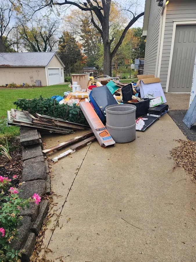 Dumpster being loaded with debris for Roofing Dumpster Rental in Bonita Springs